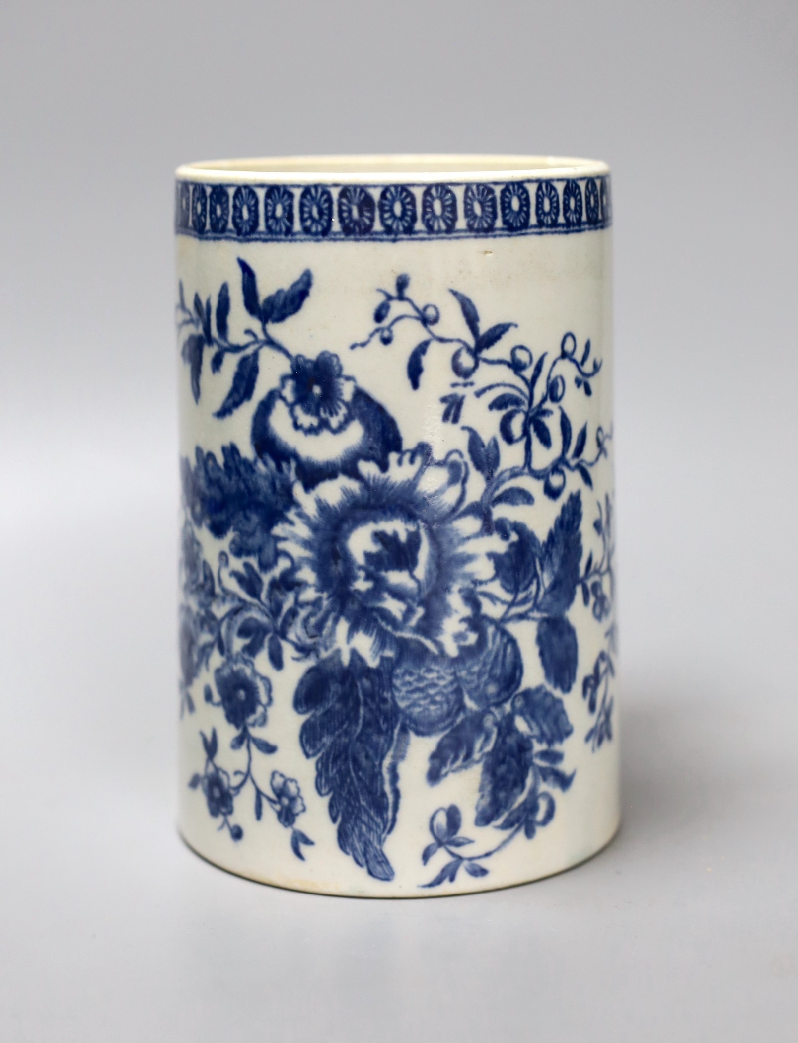 A Liverpool mug, decorated in blue underglaze with flowers and a cell border, 16cm